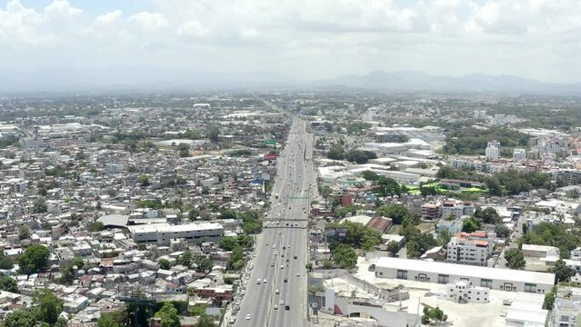 Juan Pablo Duarte Highway crossing city, Santo Domingo Oeste in Dominican Republic. Aerial forward
