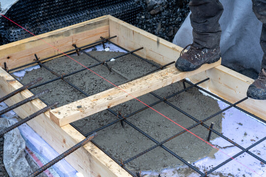 Iron net and wooden formwork with laid under insulation for pouring the foundation.