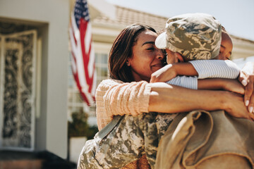 American soldier saying farewell to his family at home - obrazy, fototapety, plakaty