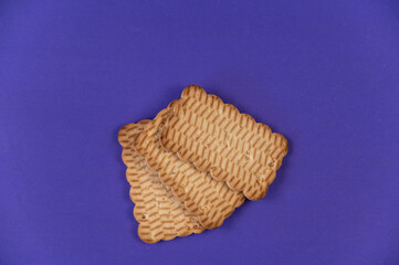 Three rectangular cookies against a blue background. Ready-to-eat treats with peanuts.