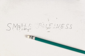Half rubbed with an eraser on the inscription SMALL BUSINESS. Handwritten text on white paper.