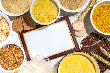 Selection of whole grains gluten free cereals. Set of various non-gluten cereals: rice, buckwheat, corn groats, quinoa, millet, oats, buckwheat, bulgur, porridge, barley, white background copy space