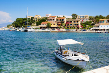 Fototapeta na wymiar Corfu island, Greece, Beautiful bay with boats in Kassiopi village 
