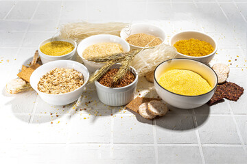 Selection of whole grains gluten free cereals. Set of various non-gluten cereals: rice, buckwheat, corn groats, quinoa, millet, oats, buckwheat, bulgur, porridge, barley, white background copy space