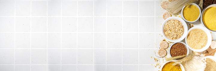 Selection of whole grains gluten free cereals. Set of various non-gluten cereals: rice, buckwheat, corn groats, quinoa, millet, oats, buckwheat, bulgur, porridge, barley, white background copy space