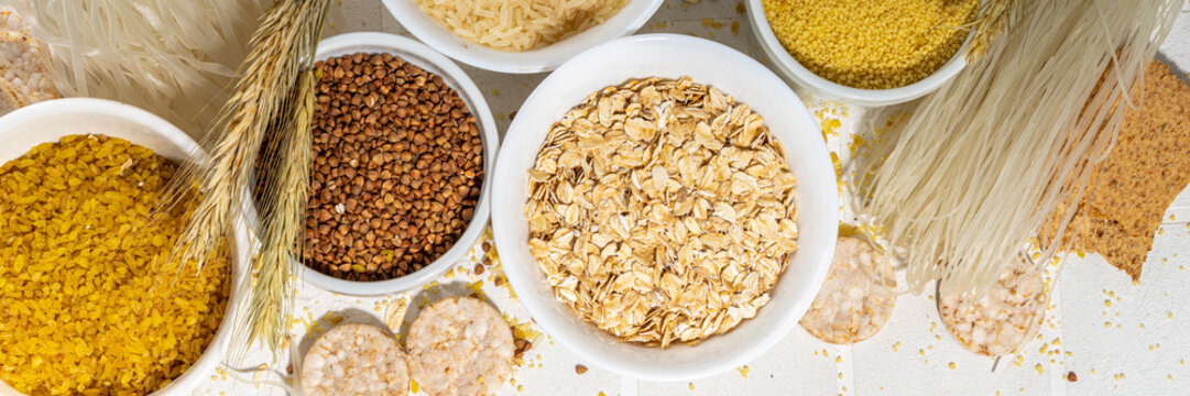 Selection of whole grains gluten free cereals. Set of various non-gluten cereals: rice, buckwheat, corn groats, quinoa, millet, oats, buckwheat, bulgur, porridge, barley, white background copy space