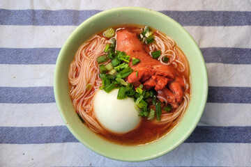 Fuzhou red rice wine mee sua noodles soup. This is the traditional dish for the Fuzhou dialect group to have this dish on 1st day Chinese New Year or Birthdays. Top view image.