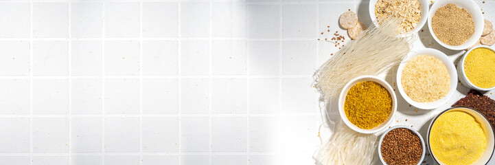 Selection of whole grains gluten free cereals. Set of various non-gluten cereals: rice, buckwheat, corn groats, quinoa, millet, oats, buckwheat, bulgur, porridge, barley, white background copy space