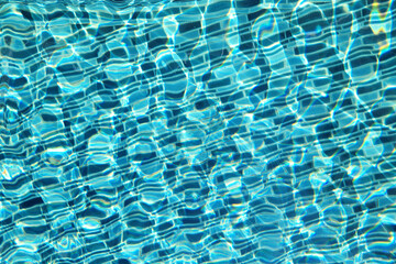 Fototapeta premium Blue ripped water an and mosaic tiles in swimming pool