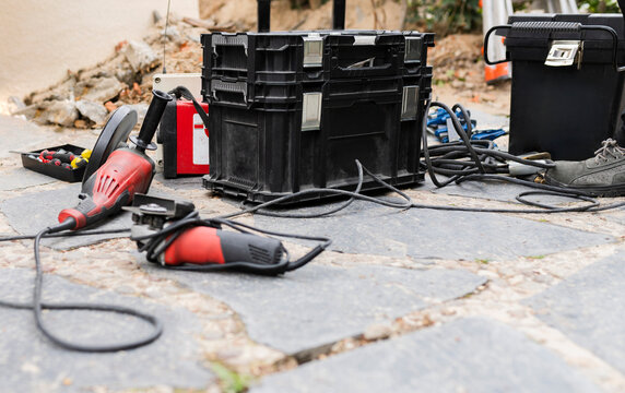 Construction work tools and toolbox on footpath
