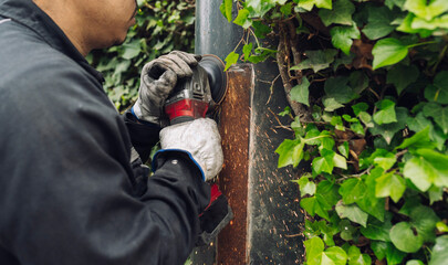 Man with circular saw working at construction site