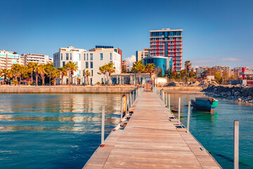 Wonderful summer cityscape of  port with old wooden pier. Stunning morning seascape of Adriatic sea with modern building on background. Nice outdoor scene of Albania, Europe.