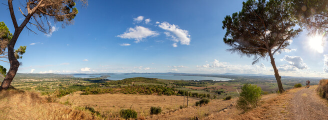 Scenic view of Lake Trasimeno on sunny day, Castiglione del Lago, Umbria, Italy