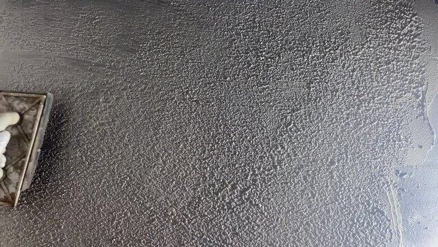 Applying a decorative microcement coating to the floor