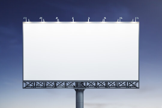 Blank white horizontal billboard on blue sky background at evening, front view. Mock up, advertising concept