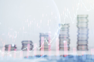 Abstract creative financial graph interface and world map on stacks of coins background, forex and investment concept. Multiexposure