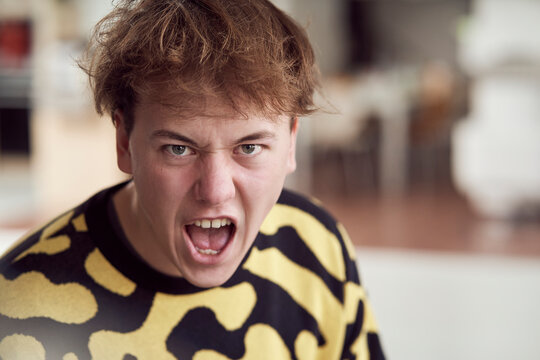 Portrait of angry young man screaming
