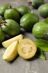 Fototapeta na wymiar Fresh green feijoa fruits on grey table, closeup