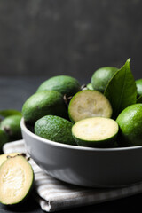 Fresh green feijoa fruits in bowl, closeup. Space for text