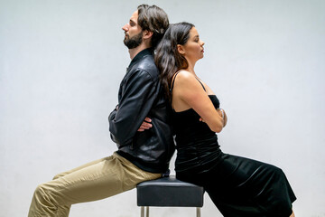 Frustrated couple sitting back to back with arms crossed