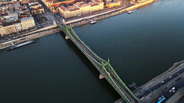 Tram passing across Liberty bridge in Budapest Hungary with Danube river view ,4K aerial topdown drone shot 1