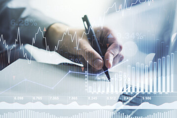 Multi exposure of abstract creative financial chart with hand writing in diary on background,...