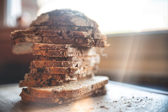 Stack of fresh baked bread slices on table
