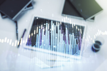 Double exposure of abstract creative financial chart and digital tablet on background, top view, research and strategy concept