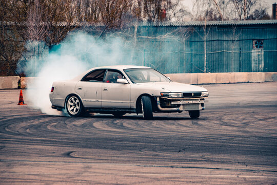 A sports car for drifting on the track performs a maneuver.