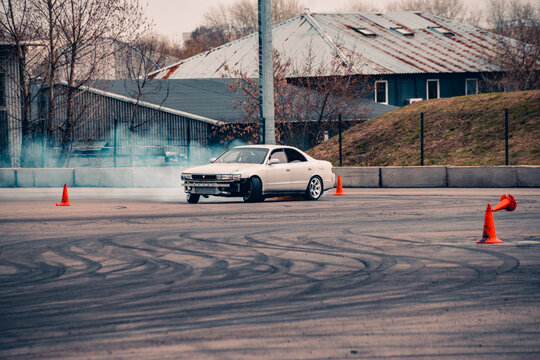 A sports car for drifting on the track performs a maneuver.