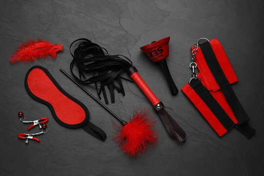 Sex toys and accessories on black background, flat lay