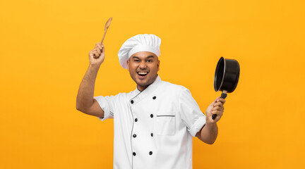 Young asian man chef in uniform holding soup pot utensils cooking in the kitchen various gesture action on isolated yellow background. Indian man Occupation chef restaurant and hotel.