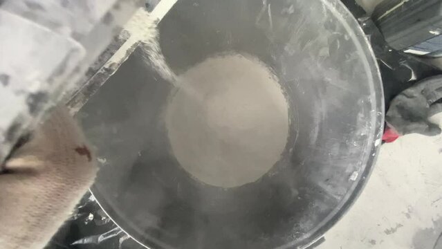 The process of combining the ingredients of the building mixture