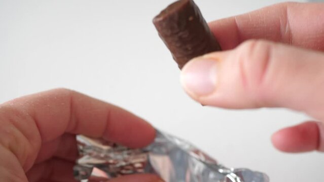 Close up of hands opening silver candy