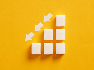 Ascending sugar cube graph with descending arrows indicating to reduce sugar intake and healthy...