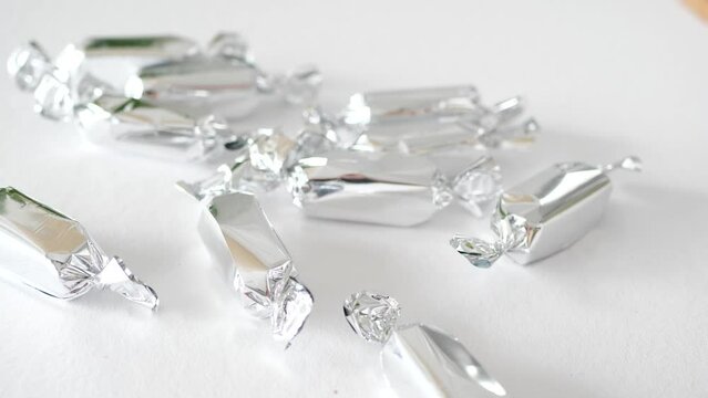 Throwing silver candy on a table