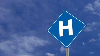 Hospital or H Road Sign on Clear Blue Sky with Rapid Moving Clouds for Text Placement