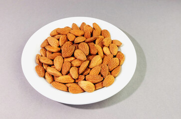 a bunch of almonds on a white plate