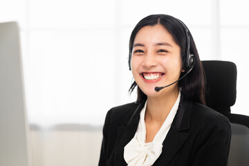 Call centre female operator. Smiling asian business woman receptionist wearing headphone video...