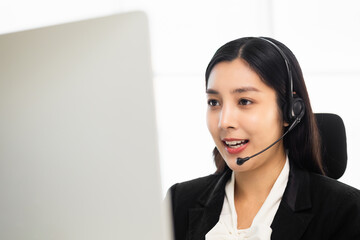 Call centre female operator. Smiling asian business woman receptionist wearing headphone video...