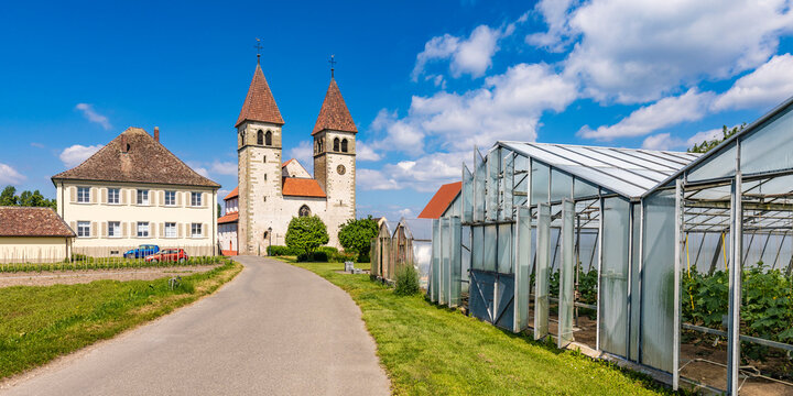 Germany, Baden-Wurttemberg, Reichenau Island, Greenhouses standing along road leading to Basilica Of Saints Peter And Paul