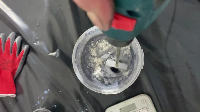 The process of combining the ingredients of the building mixture