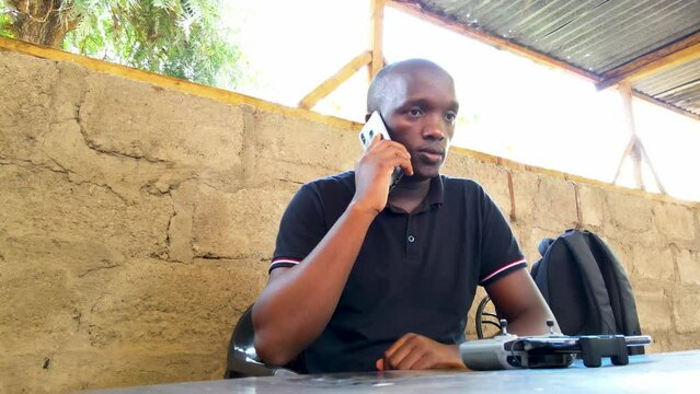 An Africa  man talking wit the phone