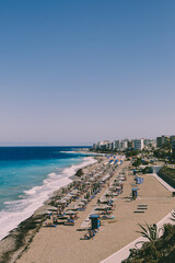 Beautiful beach with people and a part of city in Rhodes Island, Greece - 27 &lrm;September, &lrm;2021