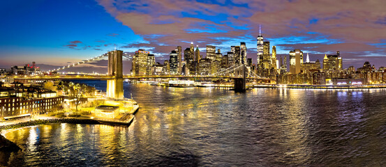 Epic skyline of New York City downtown and Brooklyn bridge evening view