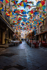 Characteristic alley in the historical center of Catania with colorful umbrellas suspended in the sky