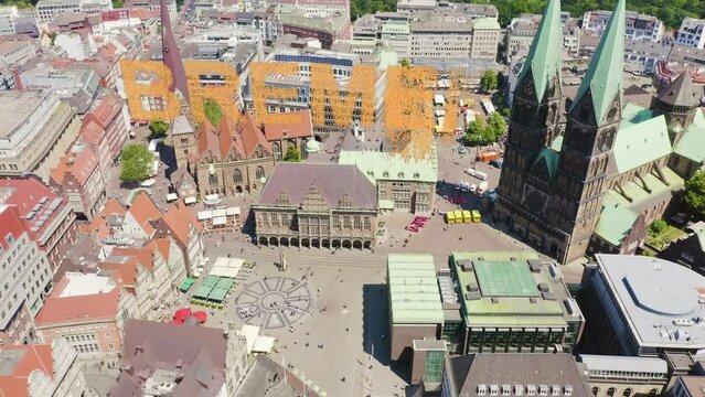 Inscription on video. Bremen, Germany. Bremen Market Square ( Bremer Marktplatz ), Bremen Cathedral ( St. Petri Dom Bremen ). View in flight. Appears from the sand, Aerial View, Point of interest