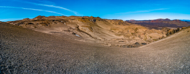 Panoramic view over Icelandic landscape of colorful volcanic caldera Askja, in the middle of volcanic desert in Highlands, with red, turquoise volcano soil and blue sky, Iceland