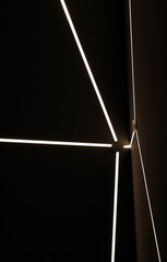 Abstract glowing lines on the wall. LED lightening. White neon light in the modern interior of a new renovation of an apartment, hotel, club, restaurant.