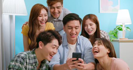 friends laugh watch phone